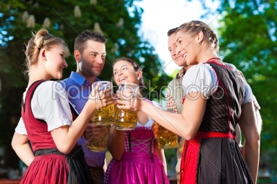 In Beer garden - friends drinking beer
