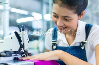 Indonesian seamstress in a textile factory