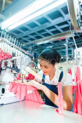 Indonesian Seamstress in Asian textile factory