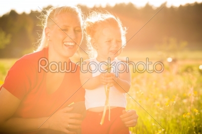 Kid in the meadow blowing dandelion seed