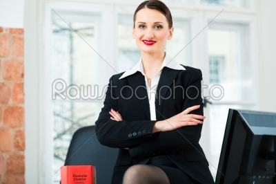 Lawyer in office with law book