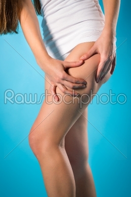 Loosing weight - young woman checking her leg