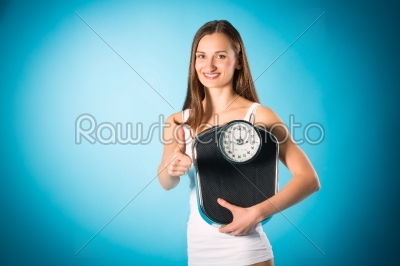 Losing weight - Young woman with measuring scale