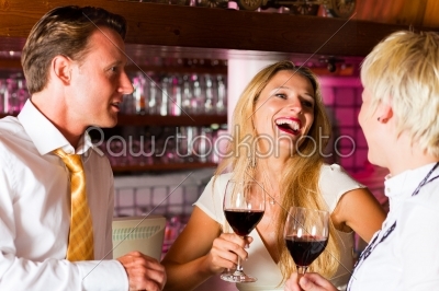 Man and two women in hotel bar
