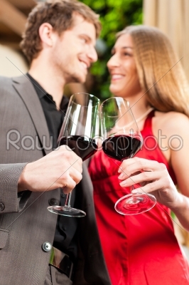 Man and woman tasting wine in restaurant