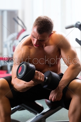Man at Dumbbell training in gym
