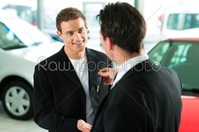 man buying car - key being given