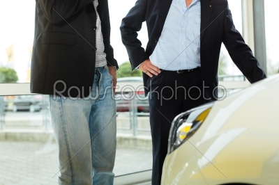 Man buying car from salesperson