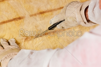 Man cutting insulation material for building