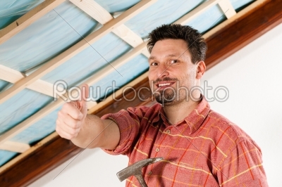 Man doing dry walling, working