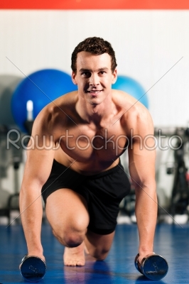 man doing pushups in gym
