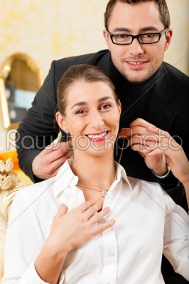 Man giving his wife a necklace