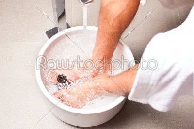 man having hydrotherapy water footbath