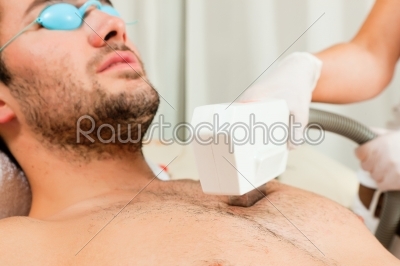 Man in cosmetic salon receiving waxing