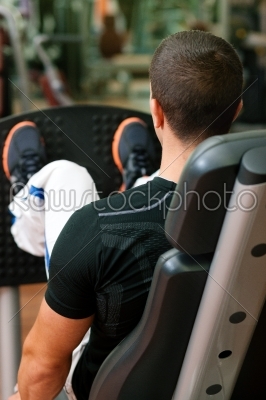Man in gym on machine exercising