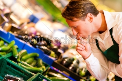 Man in supermarket as shop assistant