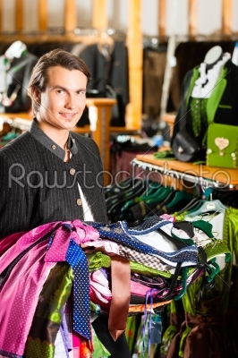 Man is buying Tracht or dirndl in a shop
