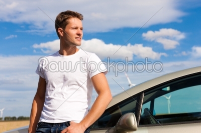 Man leaning on his car