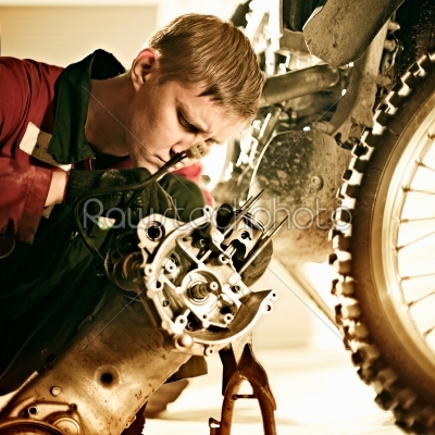 man repairing a sports bike