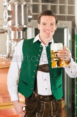 Man with beer glass in brewery