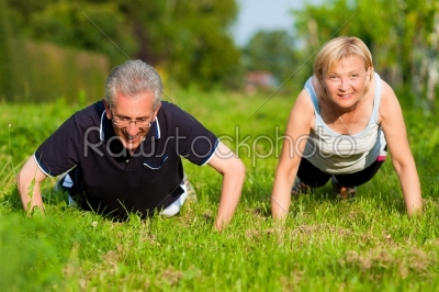 Mature couple doing sport - pushups