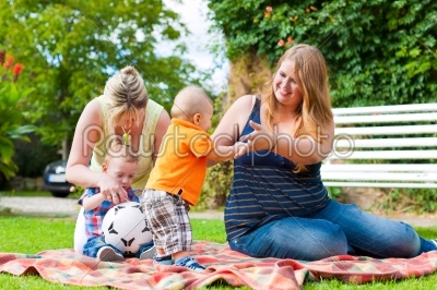 Mother and grandmother with children in a park
