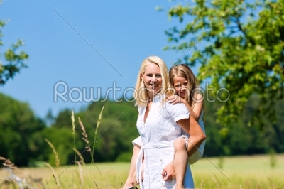 Mother with daugther in meadow