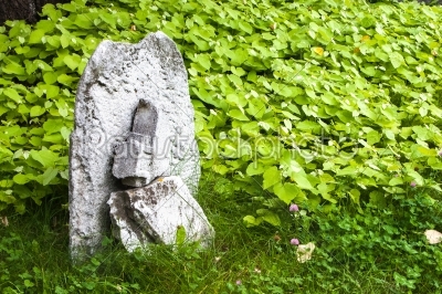 old stone cross on a green meadow