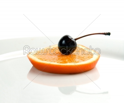orange and cherry on a plate