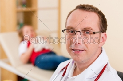 Pediatrician with little patient in his surgery