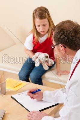 Pediatrician with little patient in his surgery