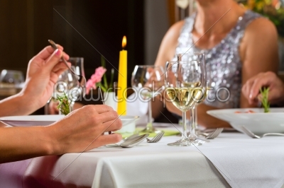 People fine dining in elegant restaurant
