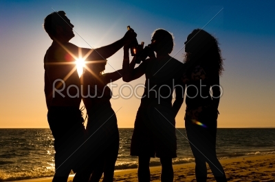 People having party at beach with drinks
