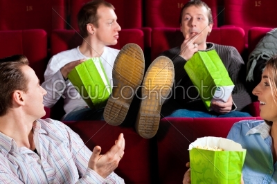 People in cinema theater eating porcorn