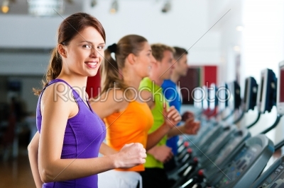 People in gym on treadmill running