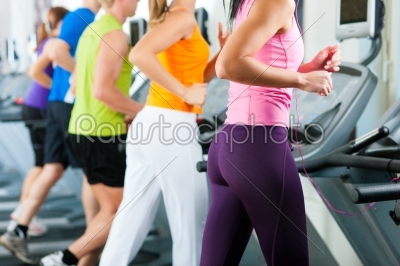 People in gym on treadmill running