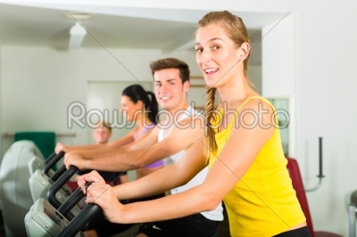 People in sport gym on the fitness machine