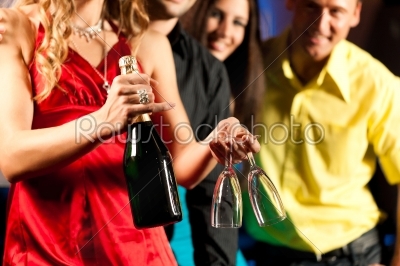 People with cocktails in bar or club