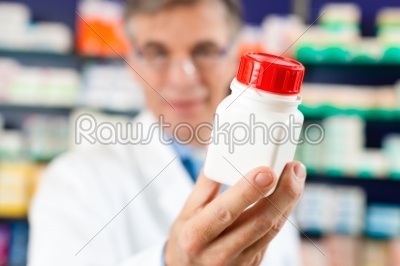 Pharmacist in pharmacy with medicament