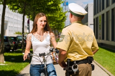 Police - woman on bicycle with police officer