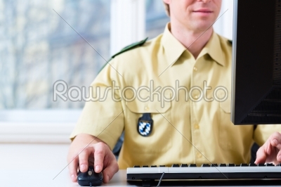 Police Officer working on desk in department