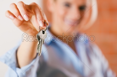 Realtor in empty apartment giving keys