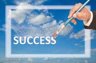 right hand holding brush over frame and sky background