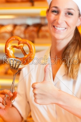 Salesperson is packing bread in bakery