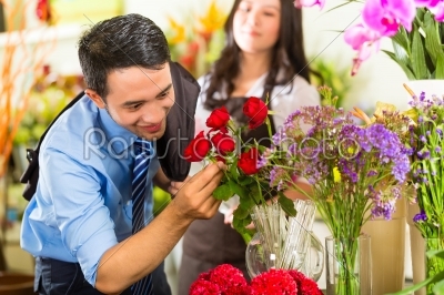 Saleswoman and customer in flower shop