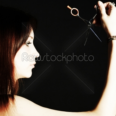 Scissors in the beautiful woman
