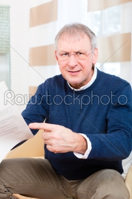 Senior at home receiving negative message