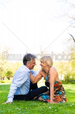 Senior couple during spring on a meadow in the city