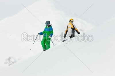 Skier and snowboarder in the snow