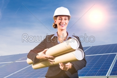Solar panels with blue sky, architect in front